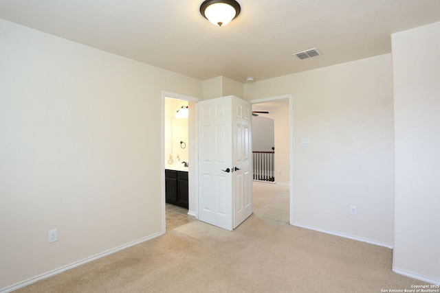 1415 Crane Ct, San Antonio, TX 78245 - unfurnished bedroom with light carpet, baseboards, and connected bathroom