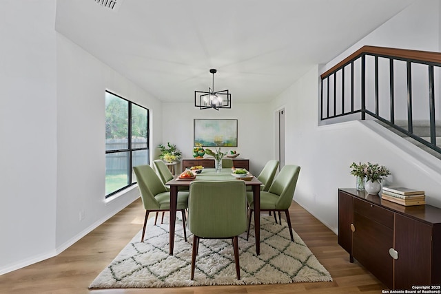 16415 Old Stable, San Antonio, TX 78247 - dining room with a chandelier, stairway, light wood-type flooring, and baseboards