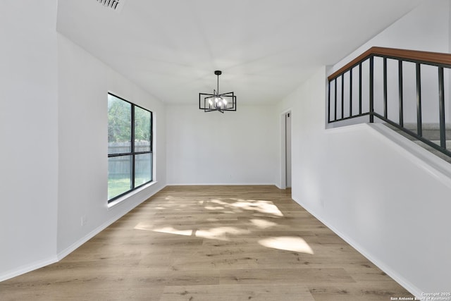 16415 Old Stable, San Antonio, TX 78247 - unfurnished dining area with a chandelier, wood finished floors, stairway, and baseboards