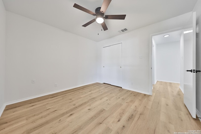 16415 Old Stable, San Antonio, TX 78247 - unfurnished bedroom with light wood finished floors, baseboards, a ceiling fan, and a closet