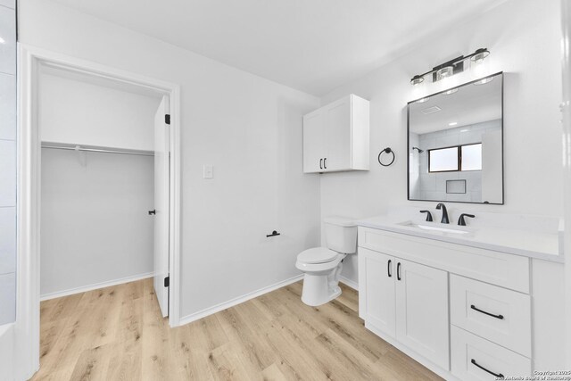 16415 Old Stable, San Antonio, TX 78247 - full bathroom with wood finished floors, vanity, toilet, and a spacious closet