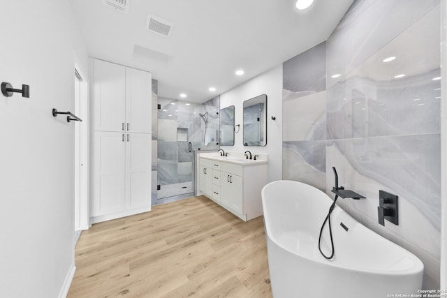 16415 Old Stable, San Antonio, TX 78247 - full bath with vanity, a stall shower, recessed lighting, wood finished floors, and a freestanding tub