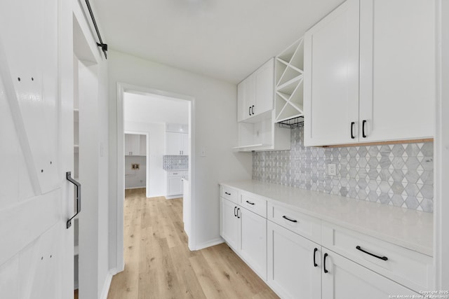 16415 Old Stable, San Antonio, TX 78247 - kitchen with open shelves, light wood-style floors, white cabinets, backsplash, and light countertops