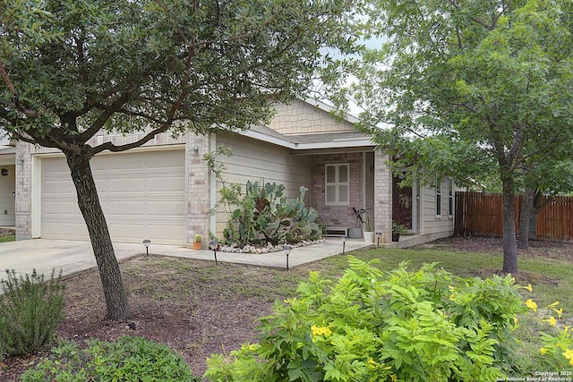 11907 Pure Silver, San Antonio, TX 78254 - view of front of house with driveway, a garage, and brick siding