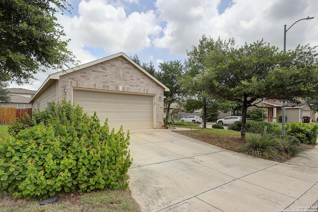 11907 Pure Silver, San Antonio, TX 78254 - view of side of home featuring brick siding and concrete driveway