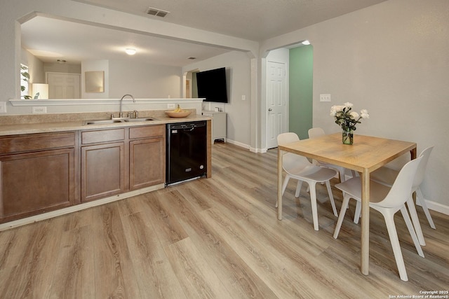 11907 Pure Silver, San Antonio, TX 78254 - kitchen with dishwasher, a sink, light wood finished floors, light countertops, and baseboards