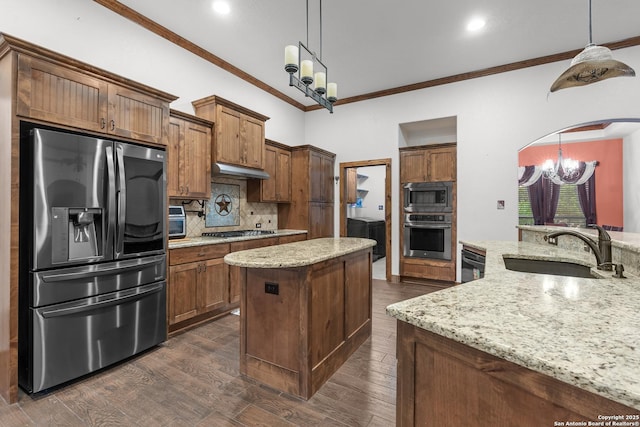 151 Native Pecan, Canyon Lake, TX 78133 - kitchen with appliances with stainless steel finishes, a sink, a chandelier, crown molding, and tasteful backsplash