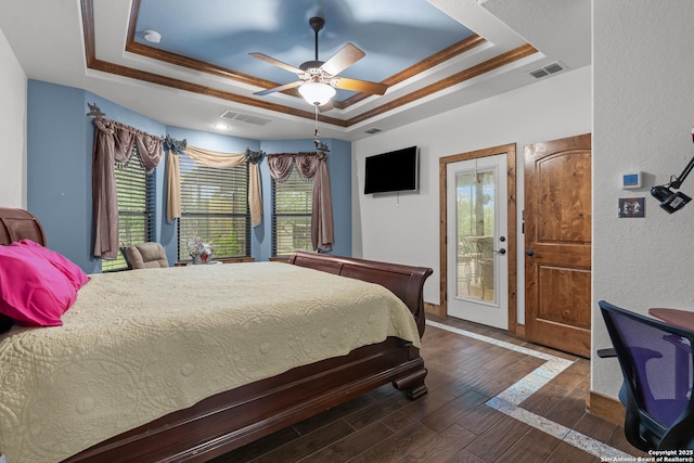 151 Native Pecan, Canyon Lake, TX 78133 - bedroom featuring a tray ceiling, multiple windows, wood finished floors, and a textured wall