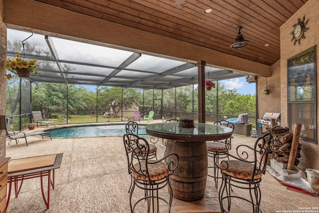 151 Native Pecan, Canyon Lake, TX 78133 - view of patio / terrace featuring an outdoor pool, a lanai, and view of wooded area