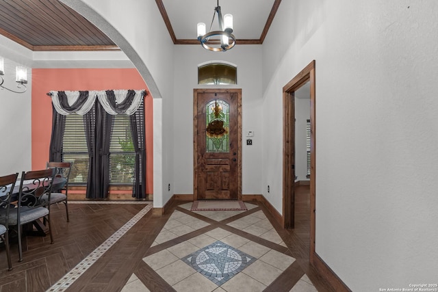 151 Native Pecan, Canyon Lake, TX 78133 - entryway featuring a chandelier, baseboards, crown molding, arched walkways, and a high ceiling
