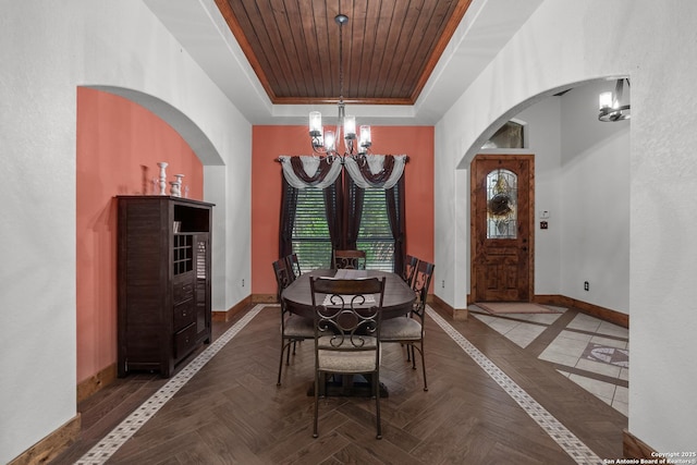 151 Native Pecan, Canyon Lake, TX 78133 - dining area with a chandelier, a raised ceiling, baseboards, wood ceiling, and arched walkways