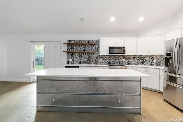 942 Lightstone, San Antonio, TX 78258 - kitchen featuring appliances with stainless steel finishes, finished concrete floors, white cabinets, open shelves, and a kitchen island