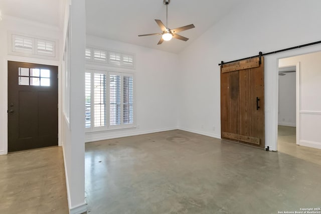 942 Lightstone, San Antonio, TX 78258 - entryway featuring finished concrete flooring, ceiling fan, high vaulted ceiling, a barn door, and baseboards