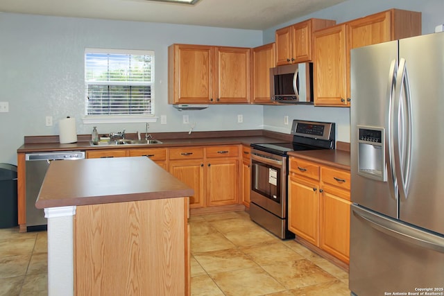 7527 Escada Crst, San Antonio, TX 78254 - kitchen with appliances with stainless steel finishes, a sink, dark countertops, a center island, and light tile patterned floors