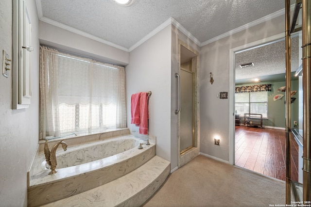 11 El Norte Cir, Uvalde, TX 78801 - full bathroom with a textured ceiling, a garden tub, baseboards, and a shower with shower door