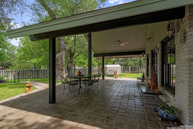 11 El Norte Cir, Uvalde, TX 78801 - fenced backyard featuring a ceiling fan, a patio, and outdoor dining area