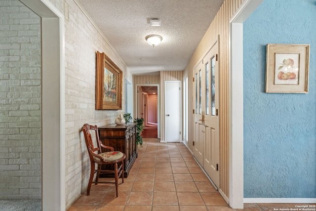 11 El Norte Cir, Uvalde, TX 78801 - hall featuring a textured ceiling, light tile patterned floors, and baseboards