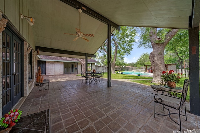 11 El Norte Cir, Uvalde, TX 78801 - fenced backyard featuring a patio, french doors, and a ceiling fan