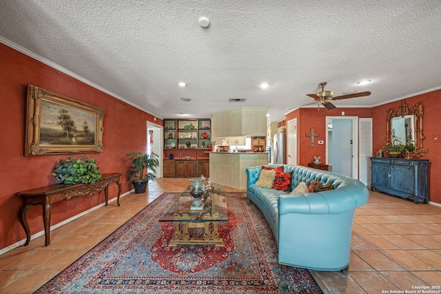 11 El Norte Cir, Uvalde, TX 78801 - living room featuring ceiling fan, a textured ceiling, ornamental molding, baseboards, and recessed lighting