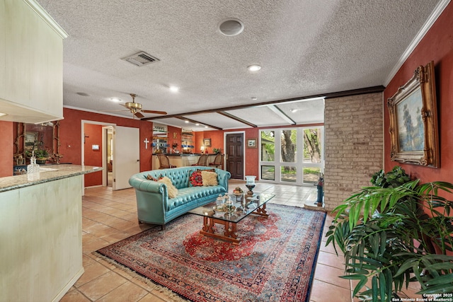 11 El Norte Cir, Uvalde, TX 78801 - living room with ceiling fan, a textured ceiling, light tile patterned flooring, crown molding, and recessed lighting