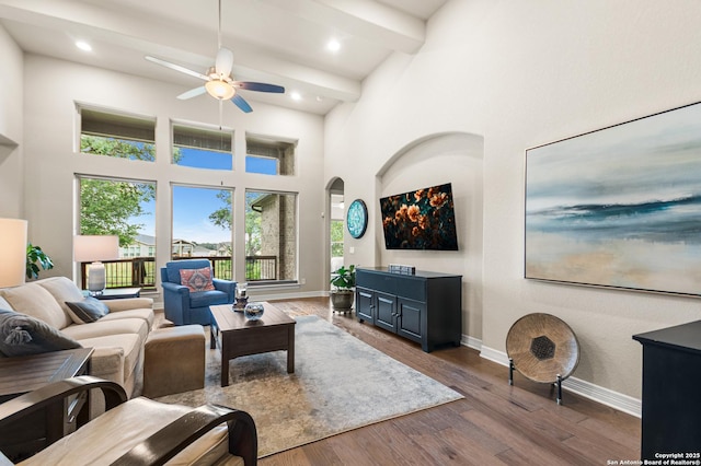 140 Cinnamon Crk, Boerne, TX 78006 - living area featuring a ceiling fan, a towering ceiling, baseboards, dark wood-type flooring, and beam ceiling