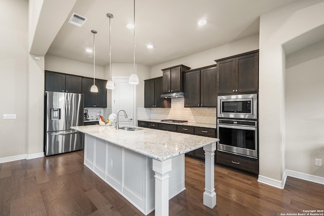 140 Cinnamon Crk, Boerne, TX 78006 - kitchen featuring appliances with stainless steel finishes, a sink, baseboards, under cabinet range hood, and recessed lighting