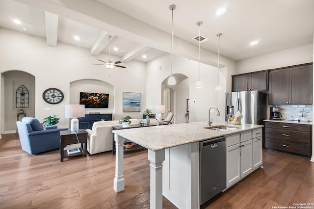 140 Cinnamon Crk, Boerne, TX 78006 - kitchen with stainless steel appliances, a sink, arched walkways, open floor plan, and ceiling fan