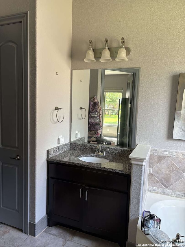 636 Carriage House # 30, Spring Branch, TX 78070 - full bath featuring vanity, tile patterned flooring, a bathtub, and a textured wall