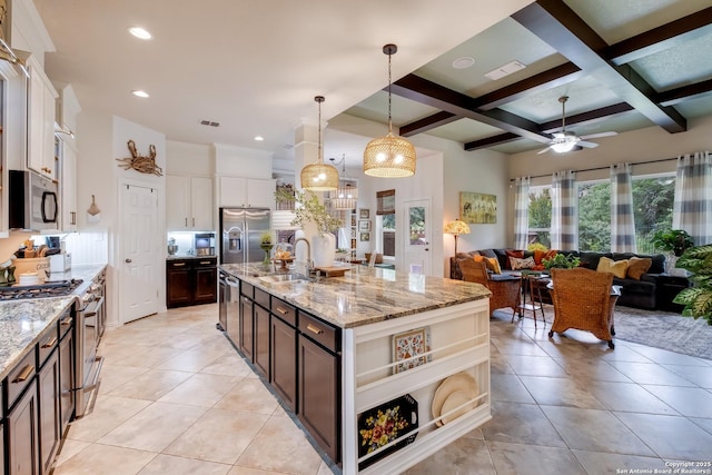 10627 Larch Grove Ct, Helotes, TX 78023 - kitchen with a sink, appliances with stainless steel finishes, a ceiling fan, beam ceiling, and light tile patterned flooring