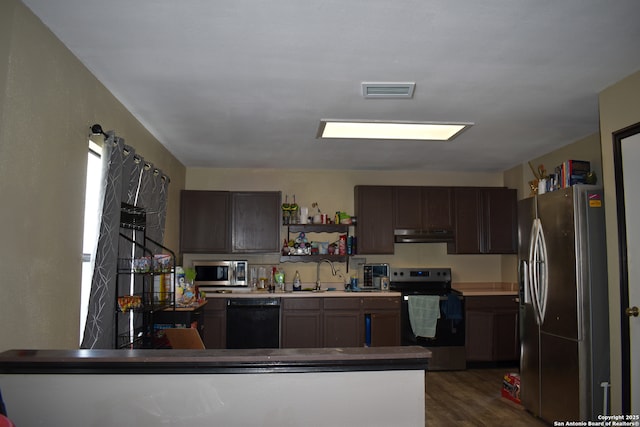 8328 Morning Grv, Converse, TX 78109 - kitchen with stainless steel appliances, under cabinet range hood, dark wood-style flooring, a sink, and open shelves