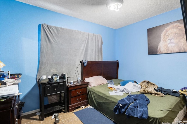 1019 Cloverbrook, San Antonio, TX 78245 - bedroom with a textured ceiling, tile patterned flooring, and baseboards