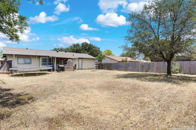 1019 Cloverbrook, San Antonio, TX 78245 - fenced backyard featuring a trampoline