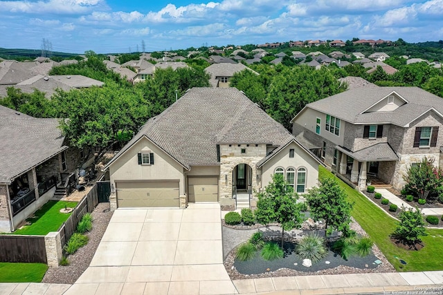 18426 Wild Onion, San Antonio, TX 78258 - view of front of home with driveway, stucco siding, an attached garage, a residential view, and stone siding