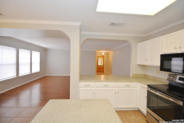 426 Twin Point Crk, Schertz, TX 78154 - kitchen featuring black microwave, stainless steel electric range oven, arched walkways, light countertops, and ornamental molding