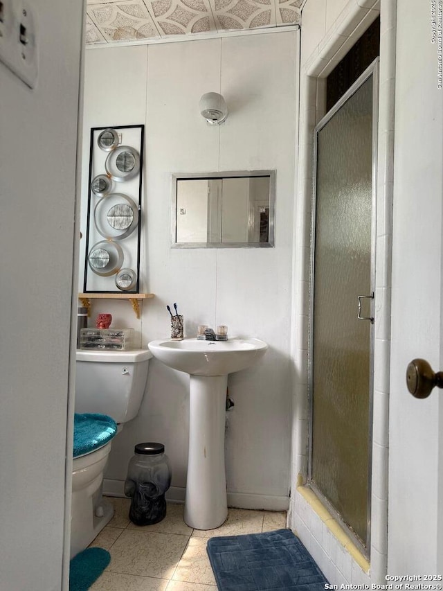 2407 Aiken, San Antonio, TX 78237 - full bath with toilet, a shower stall, tile patterned floors, baseboards, and a sink