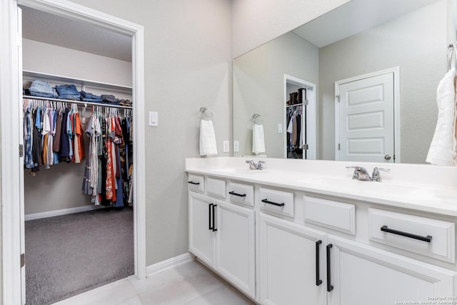 2331 Greystone Lndg, San Antonio, TX 78259 - full bathroom featuring double vanity, a walk in closet, and baseboards