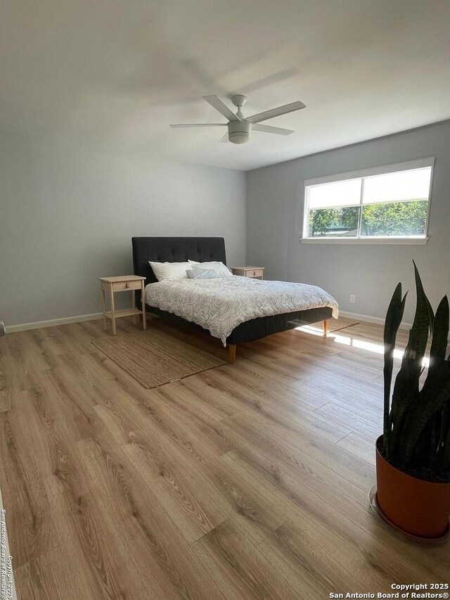 3002 Wroxton, San Antonio, TX 78217 - bedroom with light wood-style flooring, baseboards, and a ceiling fan