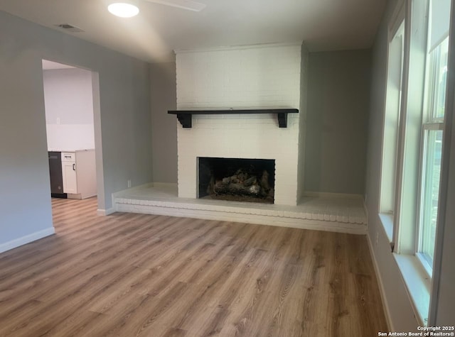 3002 Wroxton, San Antonio, TX 78217 - unfurnished living room with wood finished floors, a brick fireplace, baseboards, and a ceiling fan