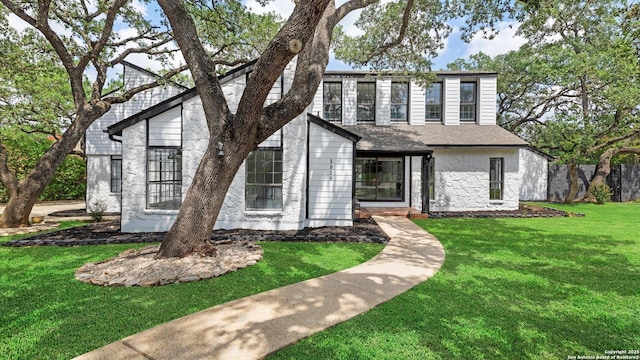 1818 Moreshead, San Antonio, TX 78231 - view of front of home featuring stone siding, a front yard, and roof with shingles