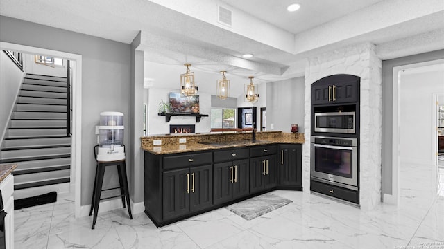 1818 Moreshead, San Antonio, TX 78231 - kitchen with appliances with stainless steel finishes, a warm lit fireplace, baseboards, dark cabinetry, and recessed lighting