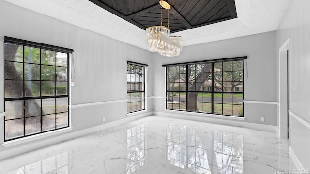 1818 Moreshead, San Antonio, TX 78231 - empty room featuring marble tiled floors, a chandelier, plenty of natural light, and baseboards