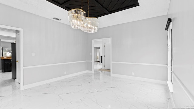 1818 Moreshead, San Antonio, TX 78231 - unfurnished room featuring marble tiled floors, a chandelier, and baseboards