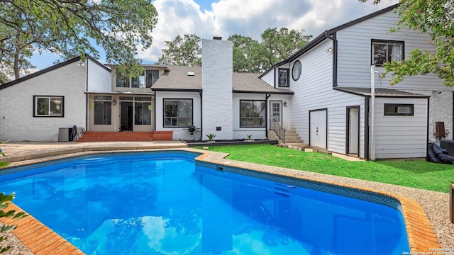 1818 Moreshead, San Antonio, TX 78231 - rear view of property with entry steps, an outdoor pool, a chimney, a lawn, and a shingled roof