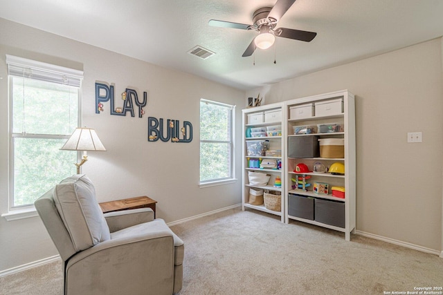 609 San Augustine, New Braunfels, TX 78132 - sitting room with healthy amount of natural light, baseboards, a ceiling fan, and carpet flooring