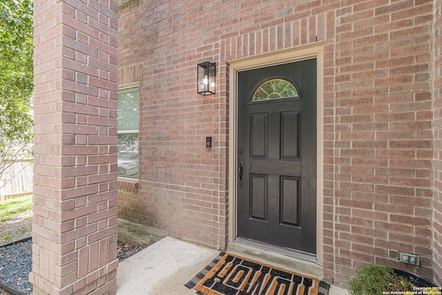 609 San Augustine, New Braunfels, TX 78132 - doorway to property featuring brick siding