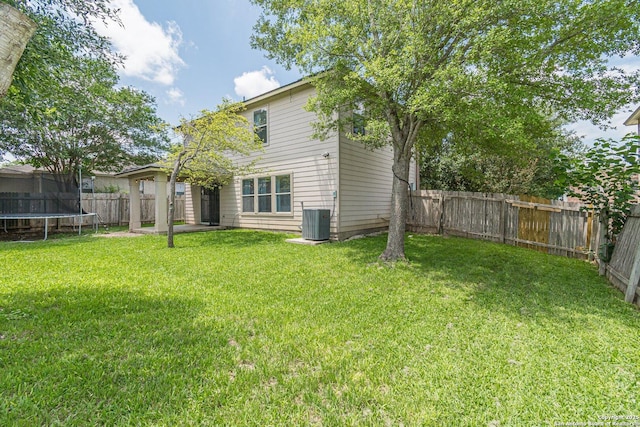 609 San Augustine, New Braunfels, TX 78132 - back of property featuring a trampoline and central AC unit