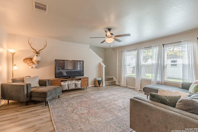 609 San Augustine, New Braunfels, TX 78132 - living room featuring light wood-type flooring, ceiling fan, stairs, and baseboards