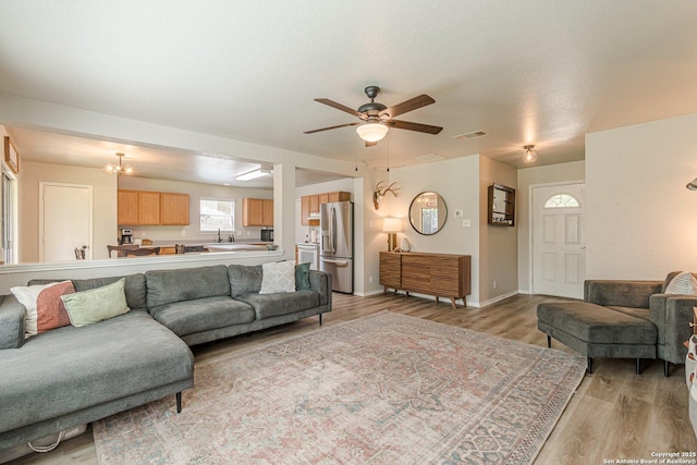 609 San Augustine, New Braunfels, TX 78132 - living area with light wood-type flooring, ceiling fan, and baseboards