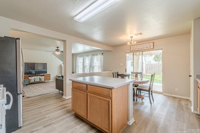 609 San Augustine, New Braunfels, TX 78132 - kitchen featuring freestanding refrigerator, light wood-style flooring, light countertops, a ceiling fan, and baseboards