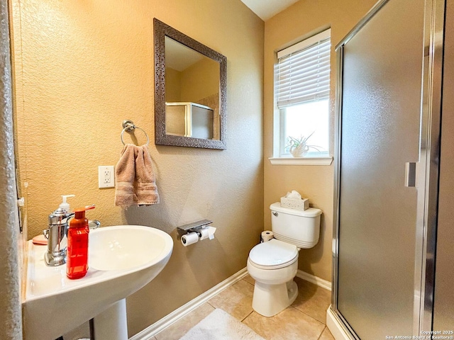 1031 Starlit Pond, San Antonio, TX 78260 - bathroom with baseboards, a shower stall, toilet, and tile patterned flooring